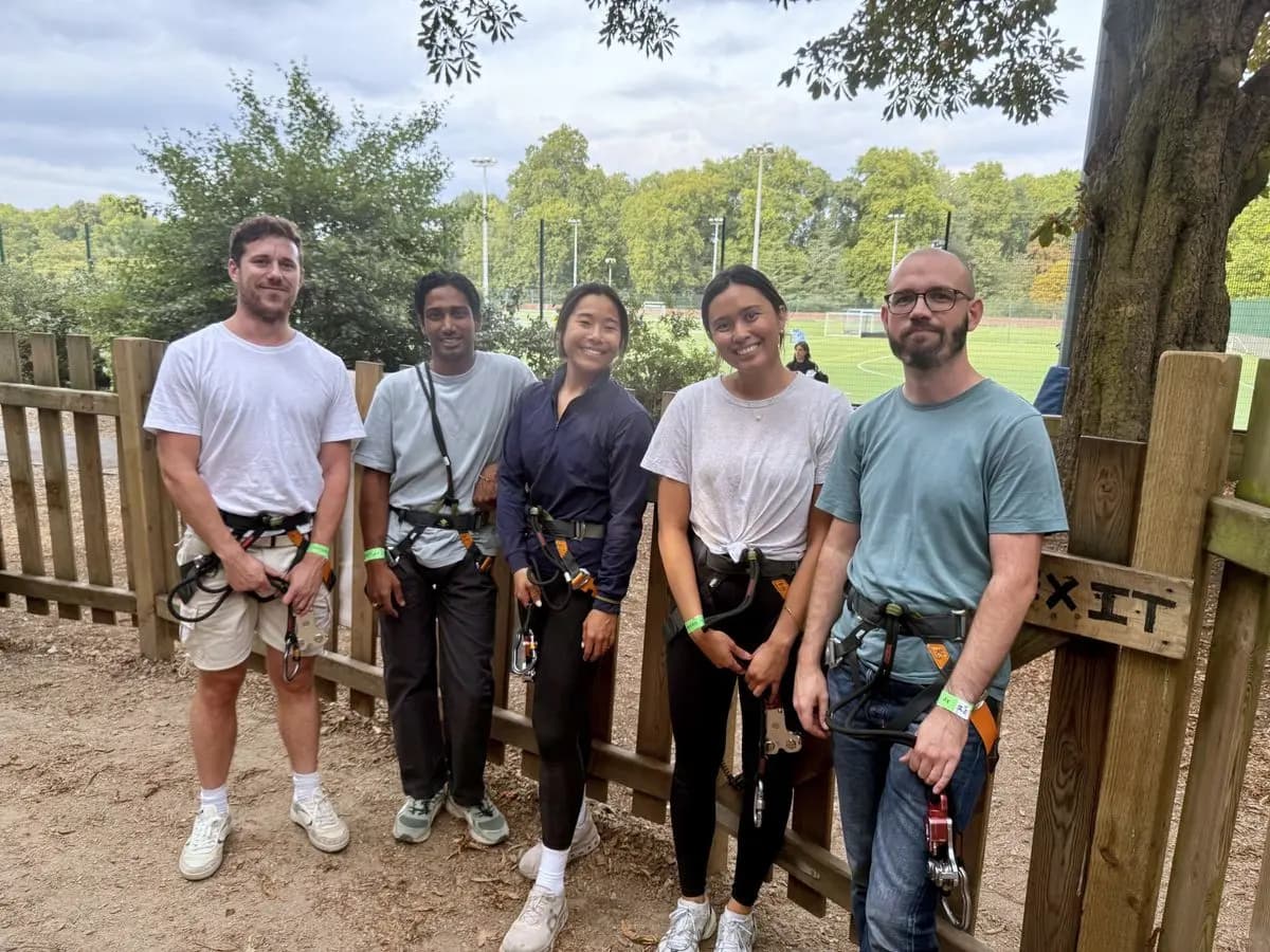 Five teammates in climbing harnesses