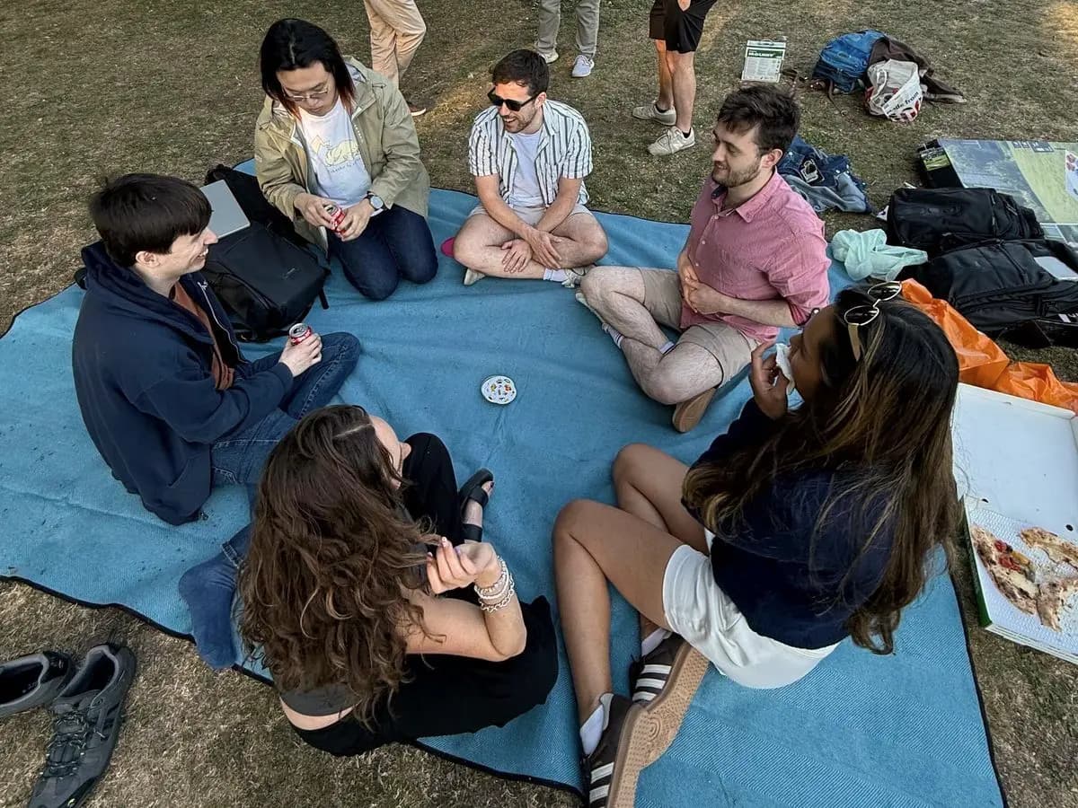 Teammates on a picnic blanket in a park
